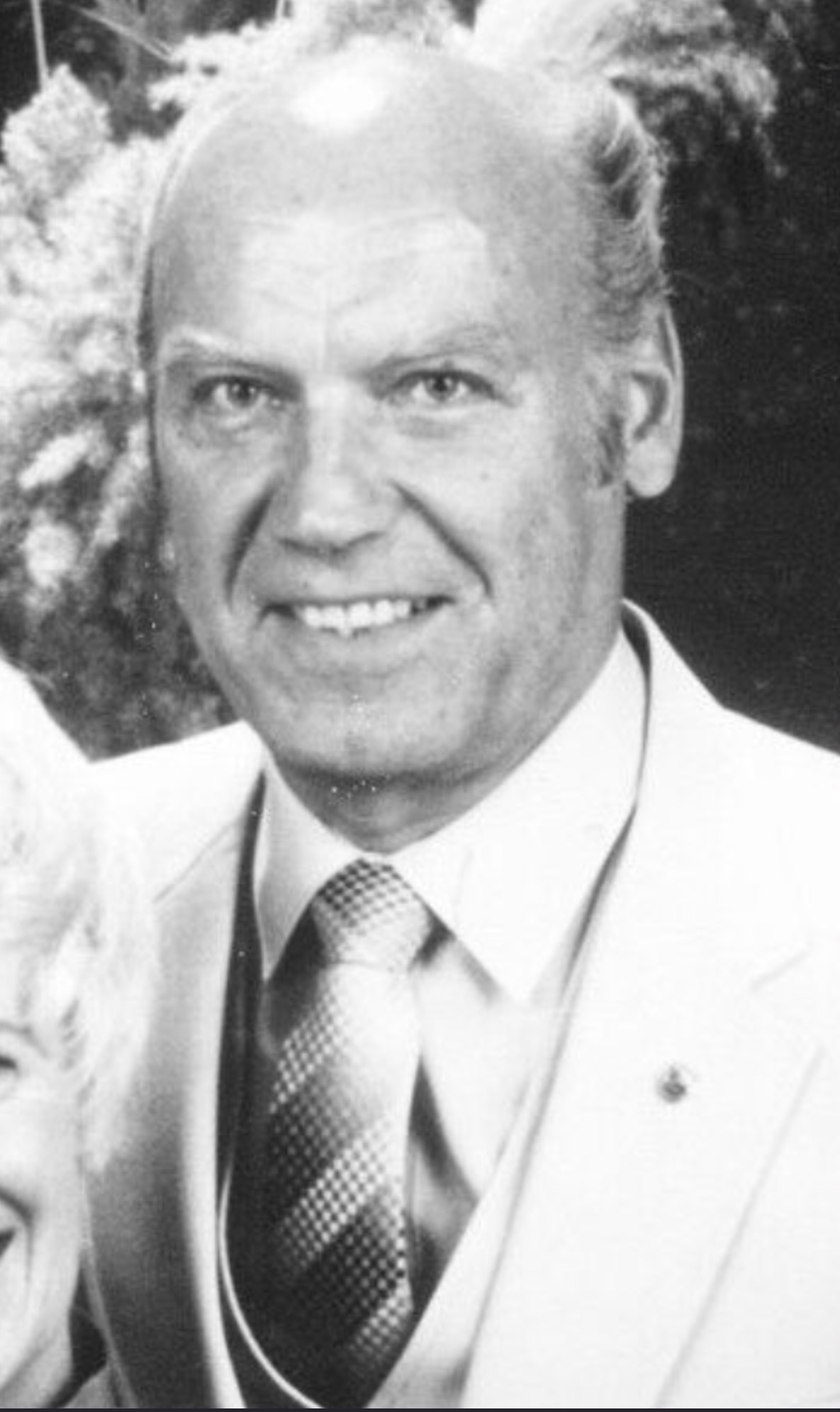 Black-and-white portrait of Stanley Lysek wearing a jacket, vest, and patterned tie.